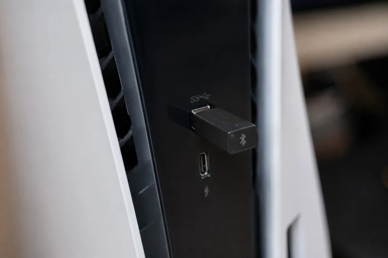 How to Connect Bluetooth Headphones to PS5 (2026) 2 USB Bluetooth adapter connected to PS5 for headphones