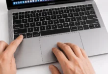 Hand pressing Control key on MacBook keyboard while clicking the trackpad to right-click