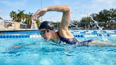 Person swimming freestyle while wearing waterproof swimming headphones