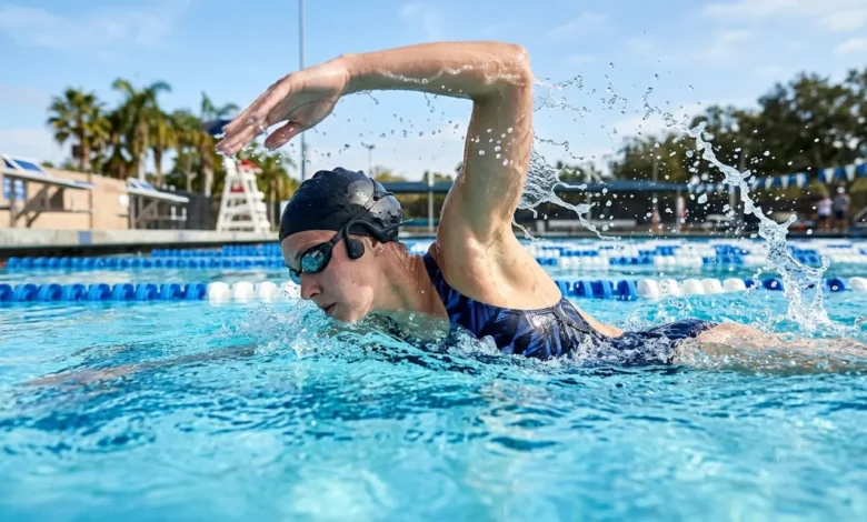 Swimming Headphones: A Complete Buying Guide 1 Person swimming freestyle while wearing waterproof swimming headphones