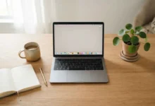 Minimal home office desk setup with a laptop, coffee, and notebook for remote work in 2026