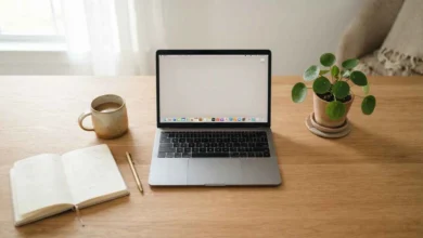 Minimal home office desk setup with a laptop, coffee, and notebook for remote work in 2026