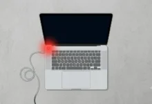 : HP laptop with a black screen and charging cable plugged in, not turning on