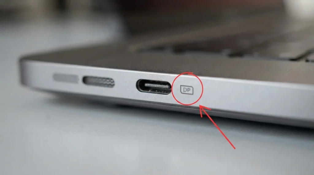 Close-up of a laptop USB-C port with DisplayPort icon needed for a monitor extender